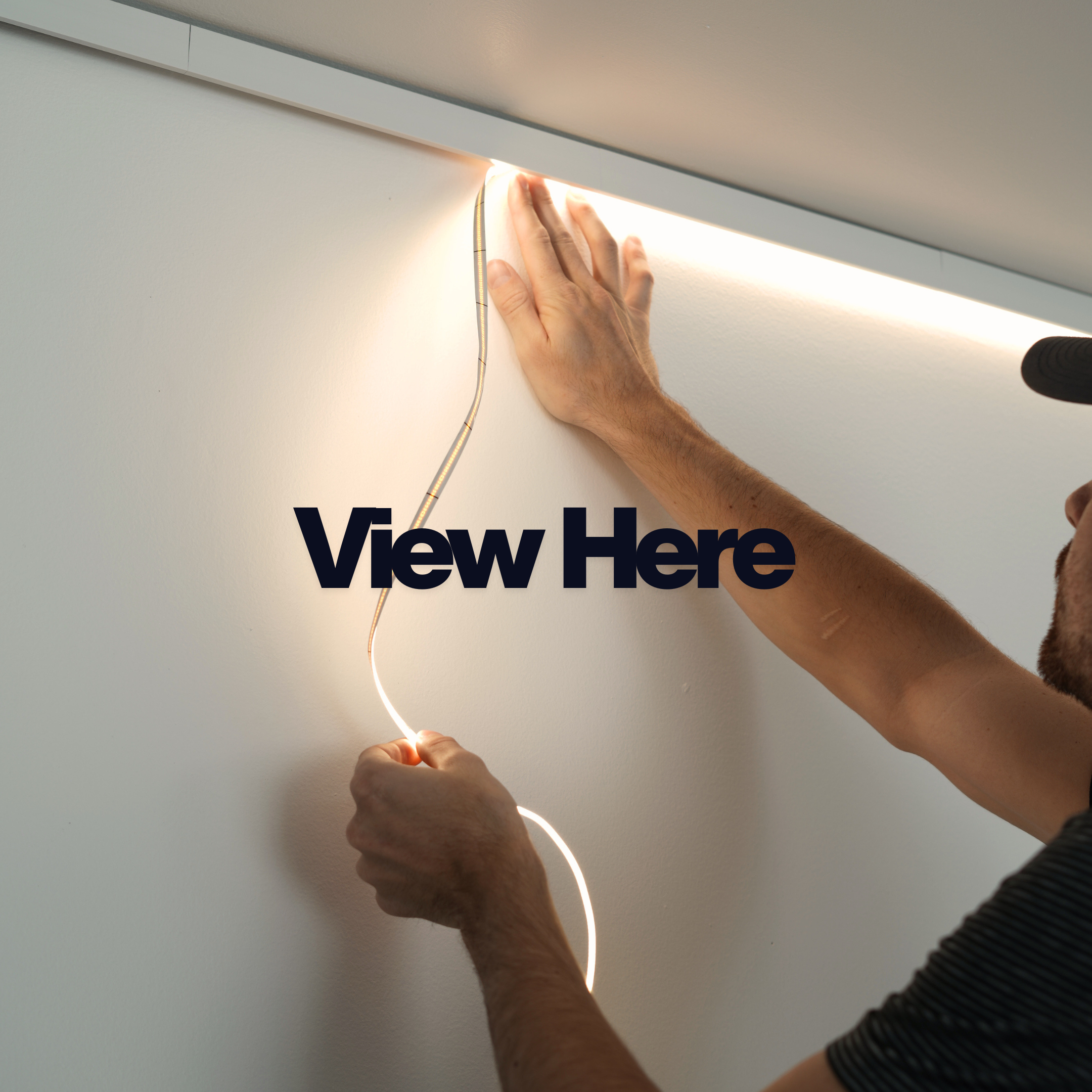 Person installing LED strip lights on a wall with 'View Here' text overlay.