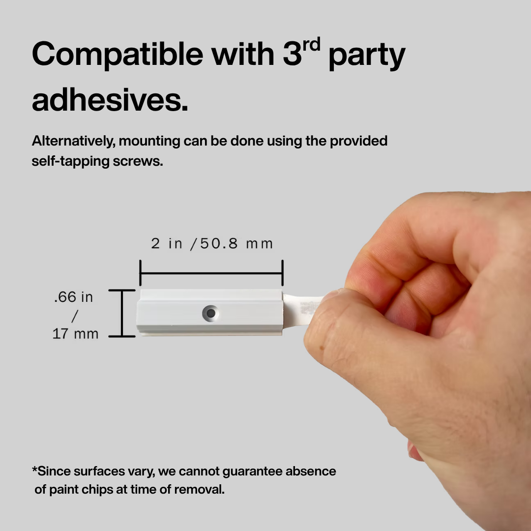 Hand holding a small white object with measurement details and text about adhesive compatibility.